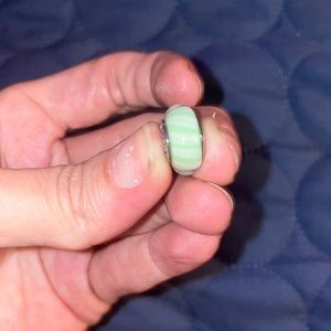 Green and white Pandora charm